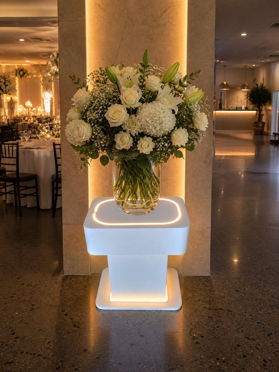 Illuminated stand with flowers at venue